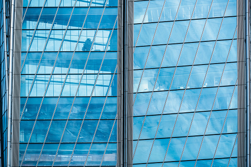 Modern office windows with clouds reflections