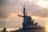 Navigation radar tower on warship at sunset close-up