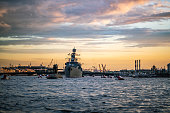 Military warship sailing in Neva River at St. Petersburg at sunset
