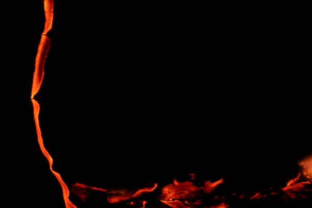 istock burning paper, glowing edge of paper on a black background 1608341306