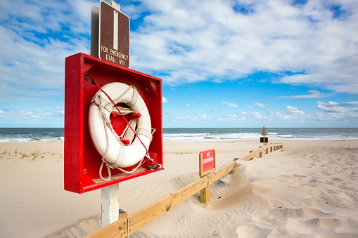 An emergency life ring and No Swimming sign near the ocean at Assateague Island, Maryland