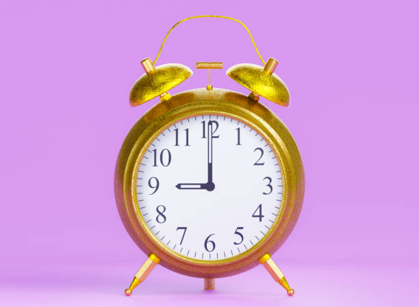 istock alarm clock gold pink background 1608375520