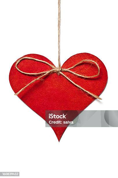 A Red Heart Hanging On A Thread On A White Background Stock Photo - Download Image Now