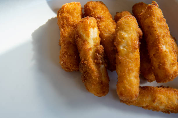 istock Delicious deep fried halloumi sticks, cheese, on a white plate. Natural lighting. Top view close up photo. Home cooking snack concept. 1608398228