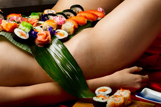 SUSHI ON A WOMAN'S NUDE STOMACH stock photo