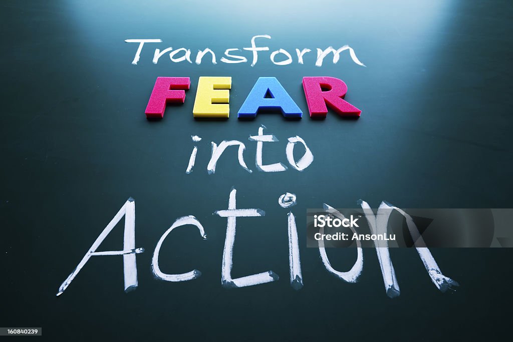 Transform fear into action concept Transform fear into action concept, colorful words on blackboard Activity Stock Photo