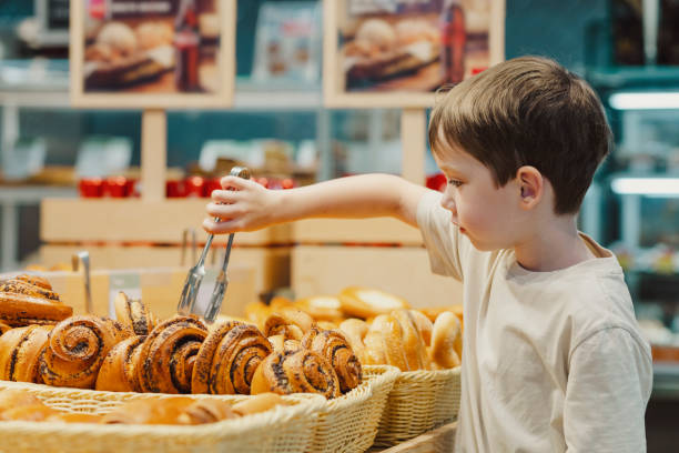 istock 6 year old boy shopping in a supermarket 1608402732