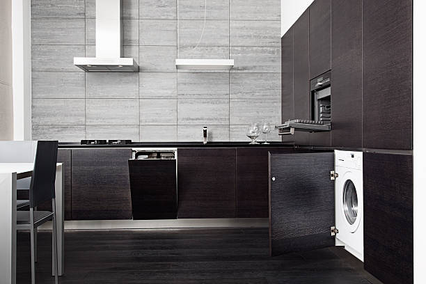 Part of black hardwood kitchen with build-in domestic technique stock photo