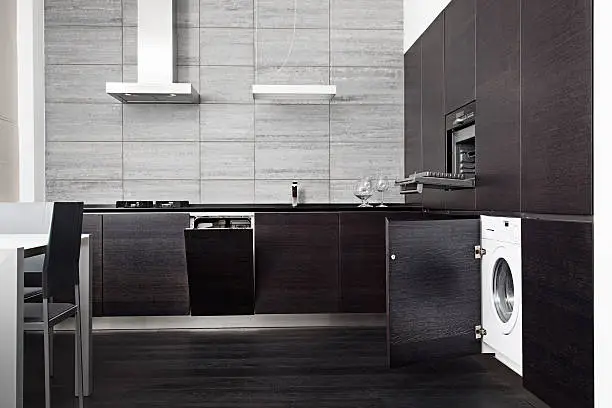 Part of black hardwood kitchen with build-in domestic technique