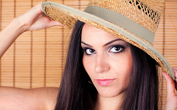 Beautiful young woman wearing a cowboy hat stock photo