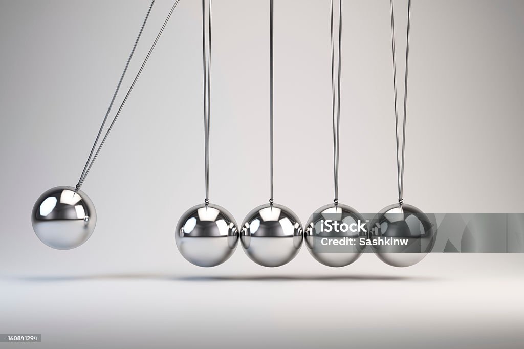 Silver balls of Newton's cradle swing back and forth Balancing balls Newton's cradle Newton's Cradle Stock Photo