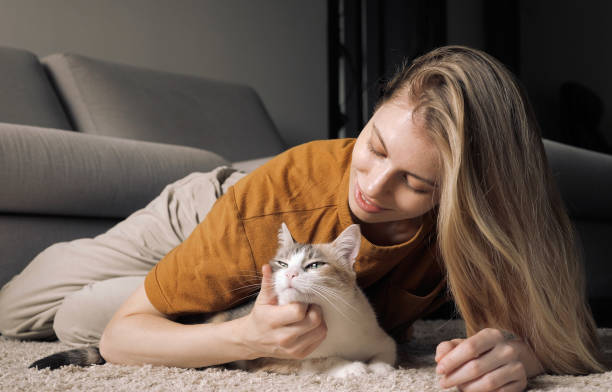 istock Happy cat At Home With Their Owner 1608451389