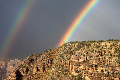 A dramatic double rainbow over Desert Watchtower after a monsoon storm in Grand Canyon National Park, Arizona, USA.