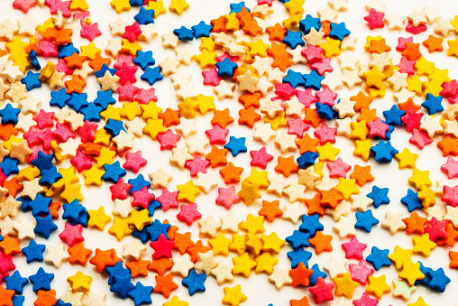 View of close-up of sugar sprinkles of star shape isolated on white