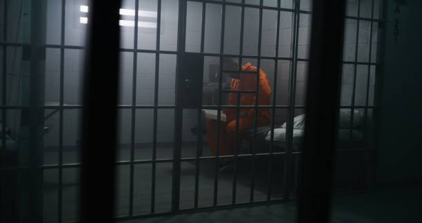 istock African American prisoner sits on the bed, reads Bible 1608543771