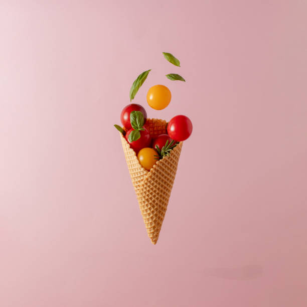 istock Cherry tomatoes and spices in a ice cream cone. Minimal food concept. Close up. Copy space. 1608557921