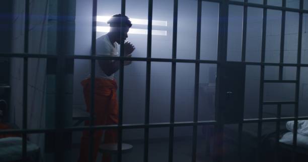 istock Male prisoner does shadow boxing in jail cell 1608573931
