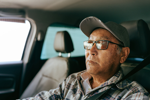 Portrait of an elderly man driving