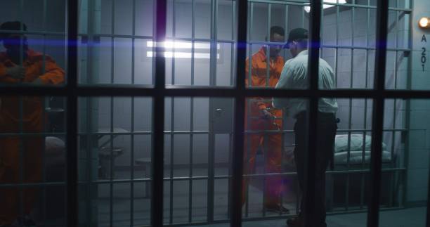 istock Warden brings guilty prisoner in jail cell 1608601429