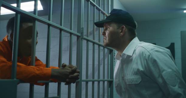 istock Warden brings guilty prisoner in jail cell 1608603503