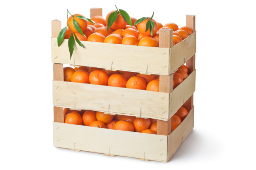 Three retail crates of ripe tangerines. Isolated on a white.