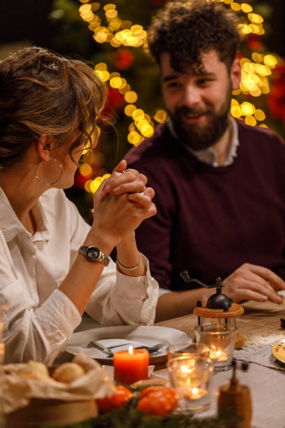 istock Young woman gesturing while sharing an interesting story with friends during a Christmas dinner party 1608614683