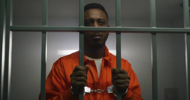 istock Prisoner in handcuffs looks at camera 1608619454