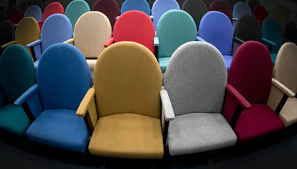 Photo of Multi colored seats in an auditorium.