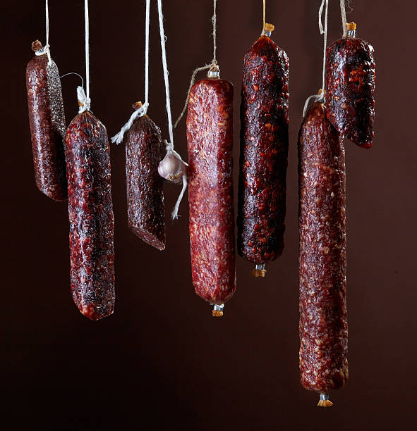 istock various hanging salami sausages 160866888