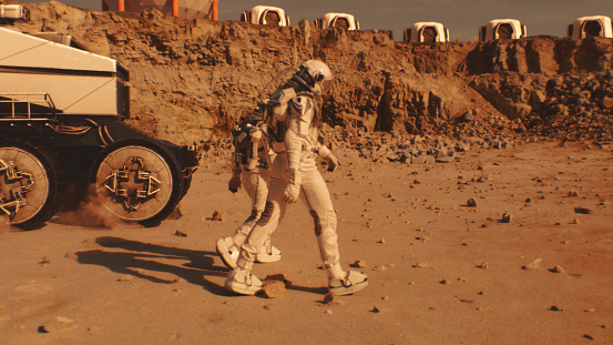 Two astronauts in spacesuits walk toward research station, colony or scientific base on Mars. AI powered rover rides in the background. Space mission. Futuristic colonization and exploration concept.