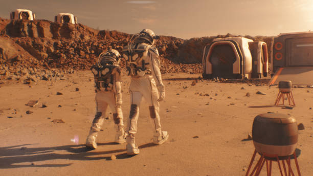 istock Two astronauts walk toward scientific base on Mars 1608676905
