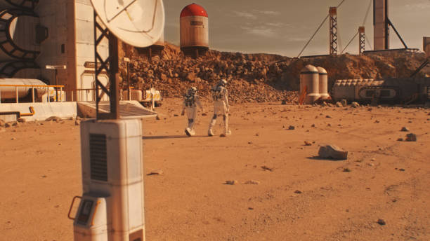 istock Two astronauts walk on Mars surface on research station 1608684725