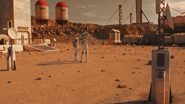 istock Two astronauts walk on Mars surface on research station 1608685279