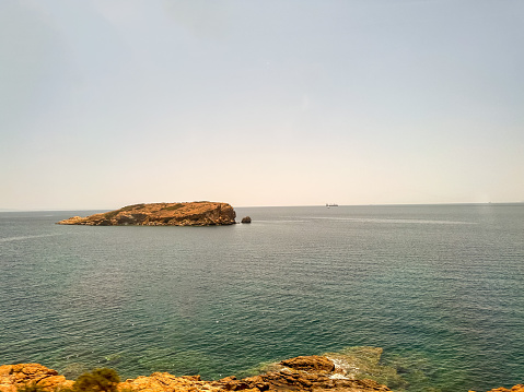 Sounion, Greece - July 25, 2023: Views of Sounion's beaches from ruins of the Temple of Poseidon