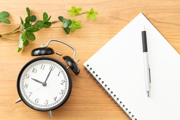 istock A notebook and an alarm clock on the desk. 1608690957