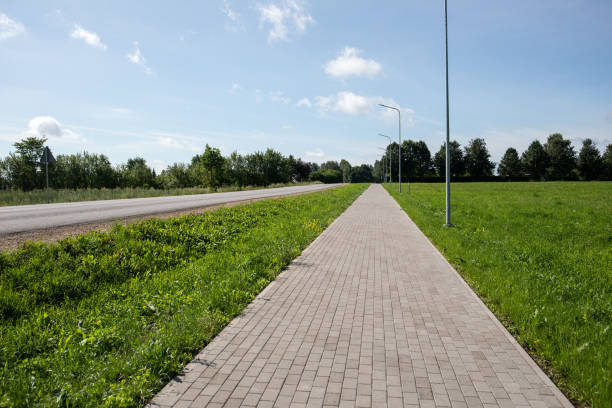 istock Paved pedestrian path along the highway. Rural area 1608695832