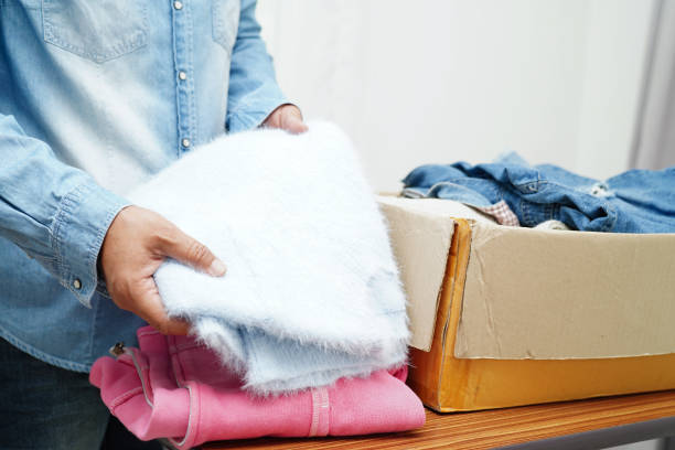 istock Clothes donations in cardboard box for volunteer. 1608720541