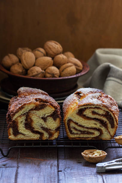 istock Traditional Easter bread with chocolate and nut filling on a wooden background. 1608726689