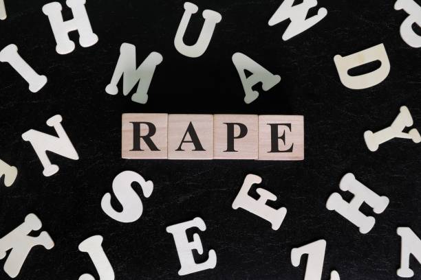 istock Rape crime concept. Word spelled on wooden blocks in dark black background. 1608757590