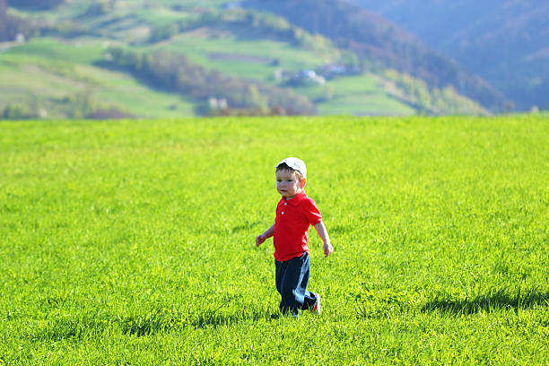 istock Walking baby boy in mountains on grass background 160879858