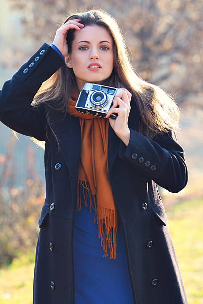 istock Beautiful girl with old camera in hand 160880063