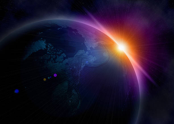 Planet earth in space with sun coming round stock photo