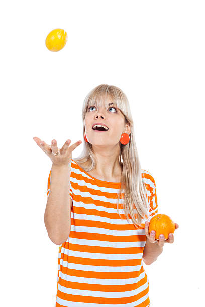 istock Beautiful girl throwing fruit in the air 160880517