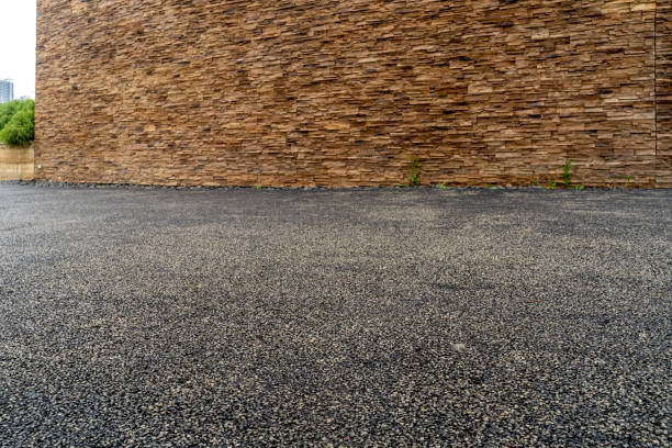 istock empty asphalt road and rocked wall as background. 1608806031
