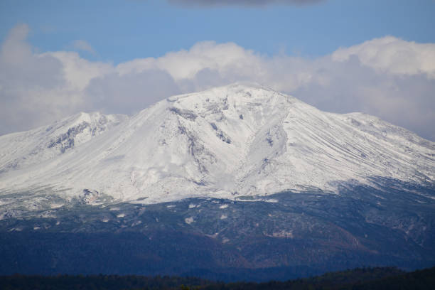 istock Snow-capped peak and autumn woodland 1608806576