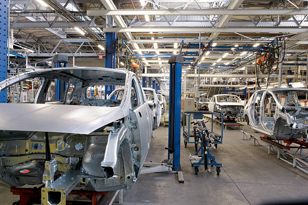 Car Production Car Industry: Robots in a Car Factory automobile industry stock pictures, royalty-free photos & images