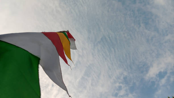 istock Colorful pennant against a cloudy sky background 1608830669