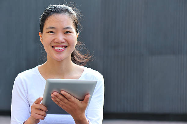 istock young woman using digital tablet outdoor 160883392