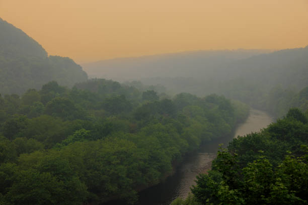 Lehigh river winds through valley. Smoky haze and fog from Canadian wildfires under Jim Thorpe (Mauch Chunk) in Appalachian Mountains, Poconos, Pennsylvania.