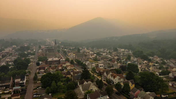 istock Mountain range in wildfire smog above small community. Jim Thorpe, Appalachian Mountains, Poconos, PA. Aerial view of townscape 1608843837